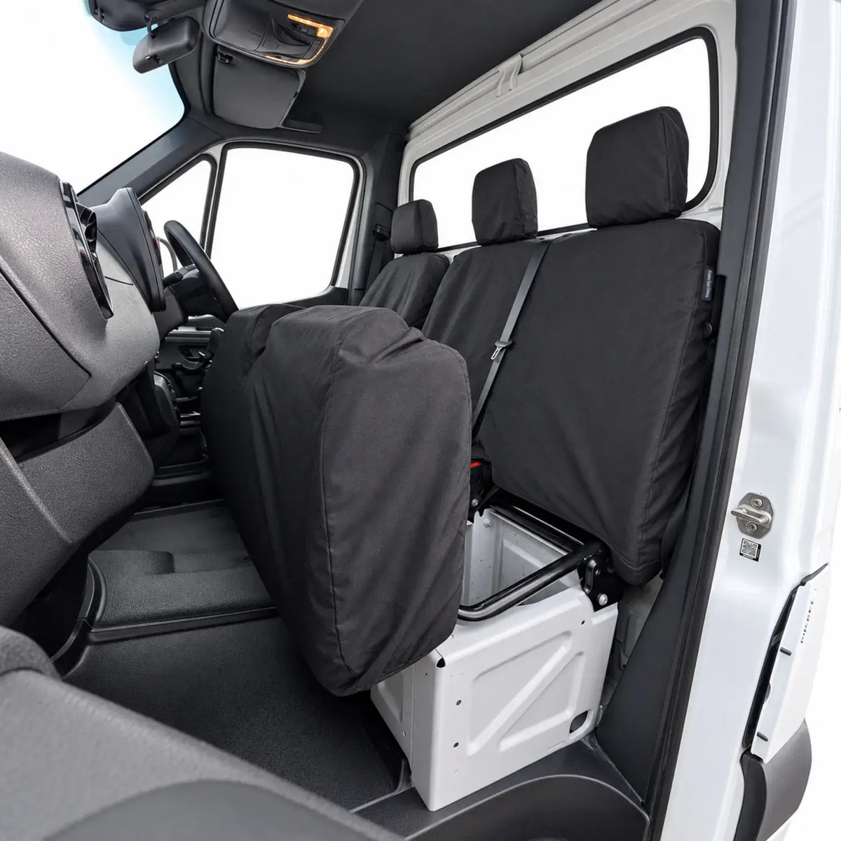 Black Mercedes Sprinter seat covers on a folded passenger seat and rear bench