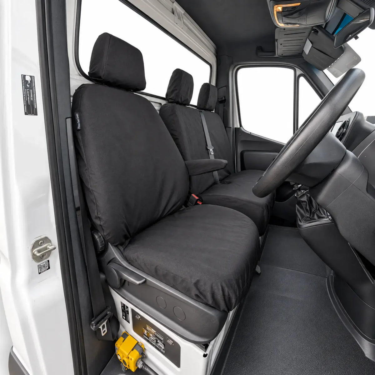 Black covers fitted to the driver seat and double passenger bench