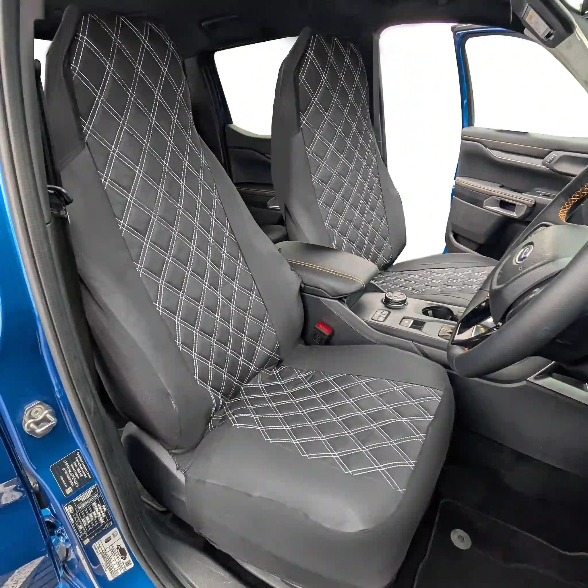 Black diamond-patterned car seat covers in a vehicle interior.