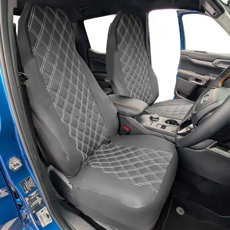 Black diamond-patterned car seat covers in a vehicle interior.