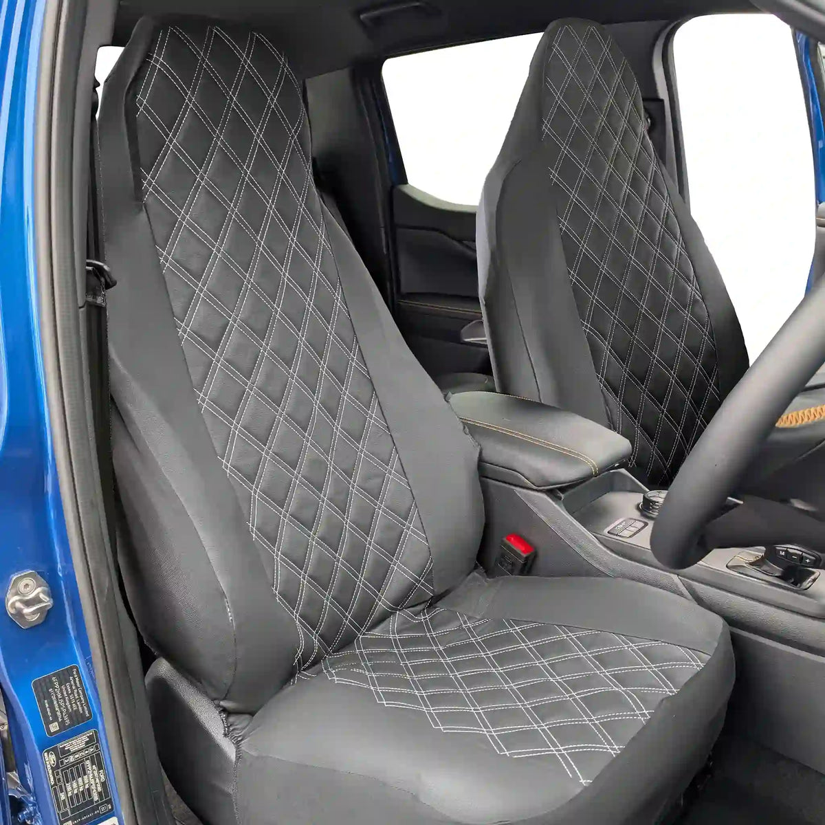 Black diamond-patterned car seat covers inside a vehicle.