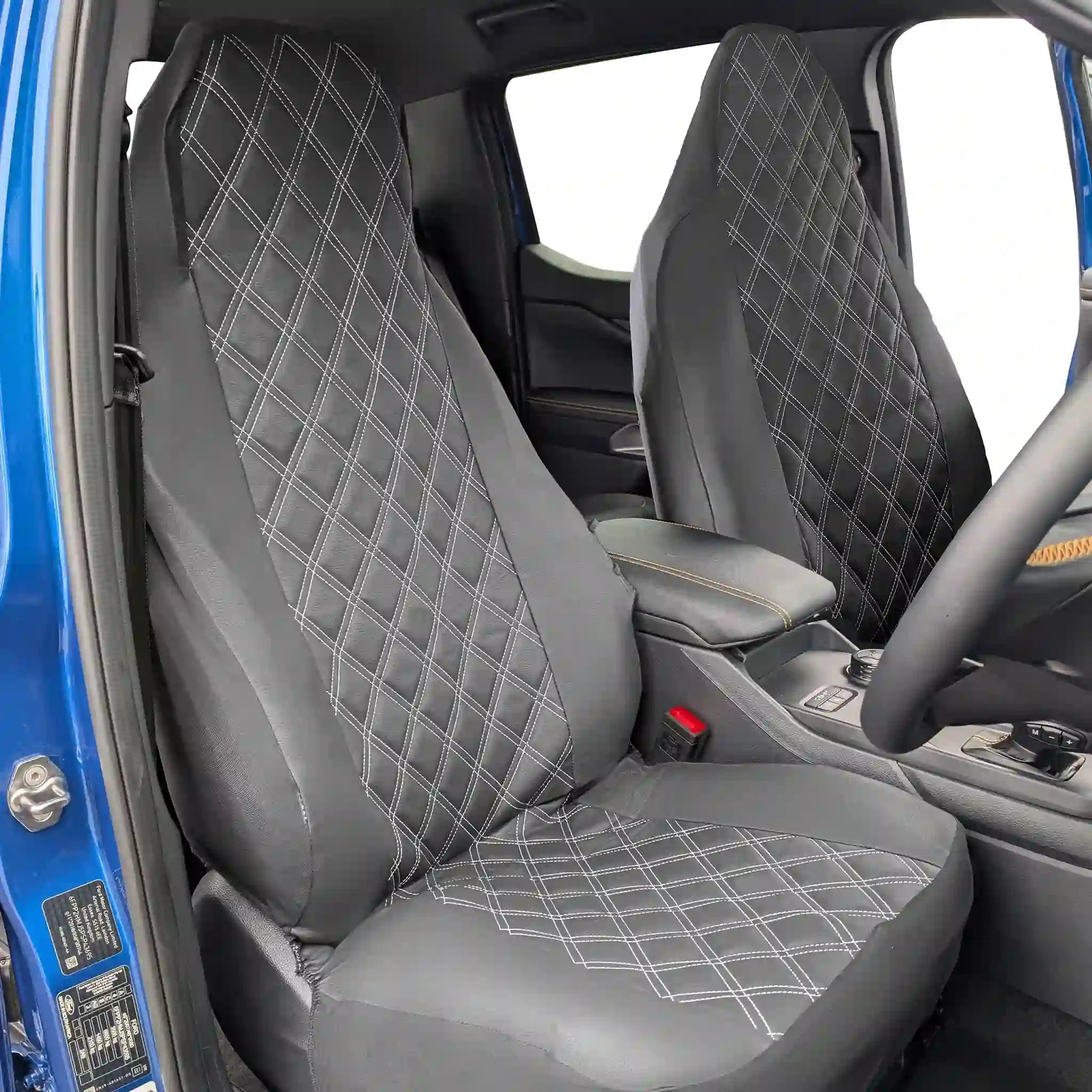 Black diamond-patterned car seat covers inside a vehicle.