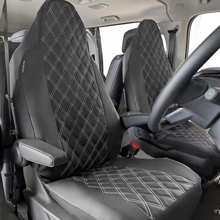 Black diamond-patterned car seat covers inside a vehicle with armrests