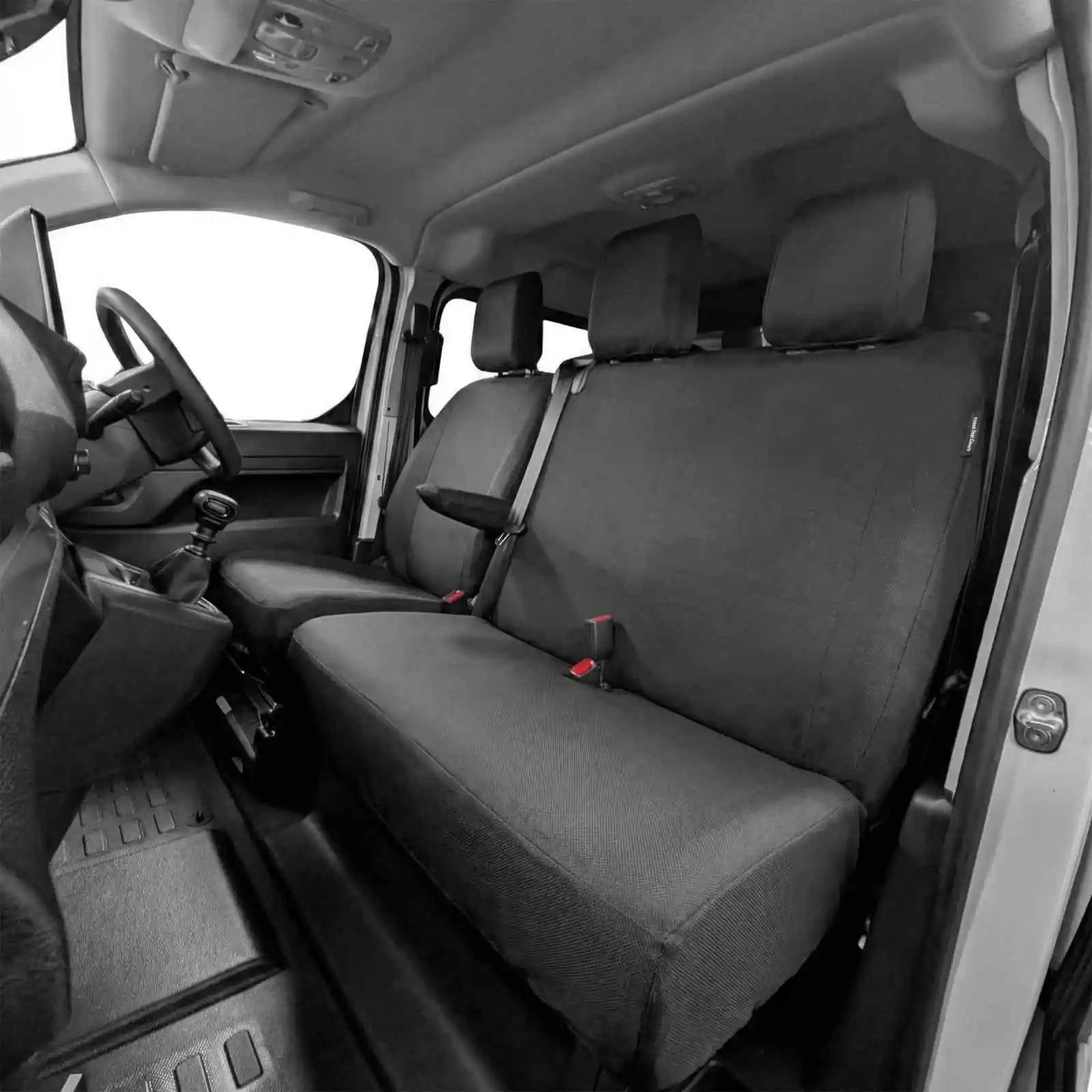 Car interior with black seat covers on the front seats