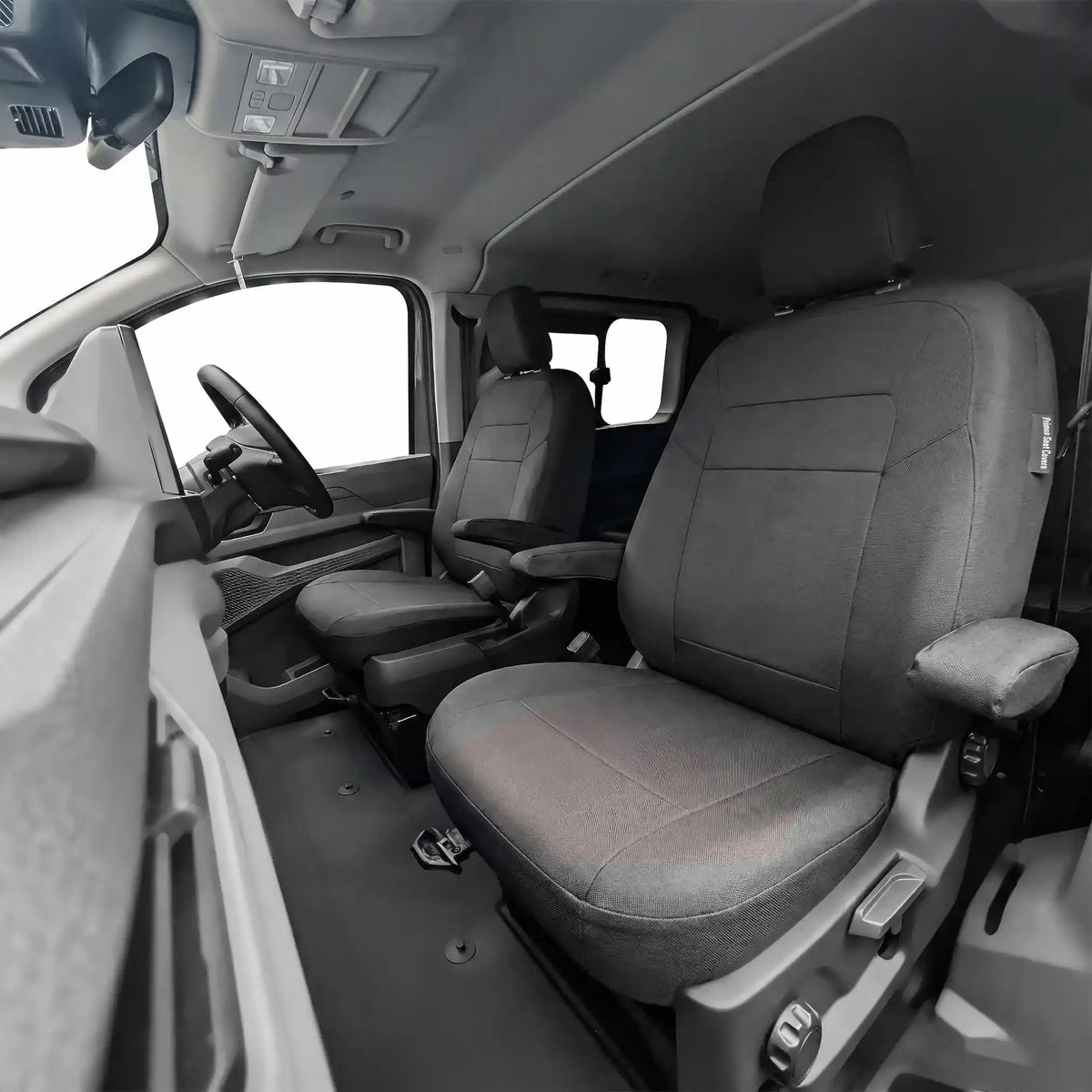 Black seat covers interior of a VW T7 with seats and dashboard