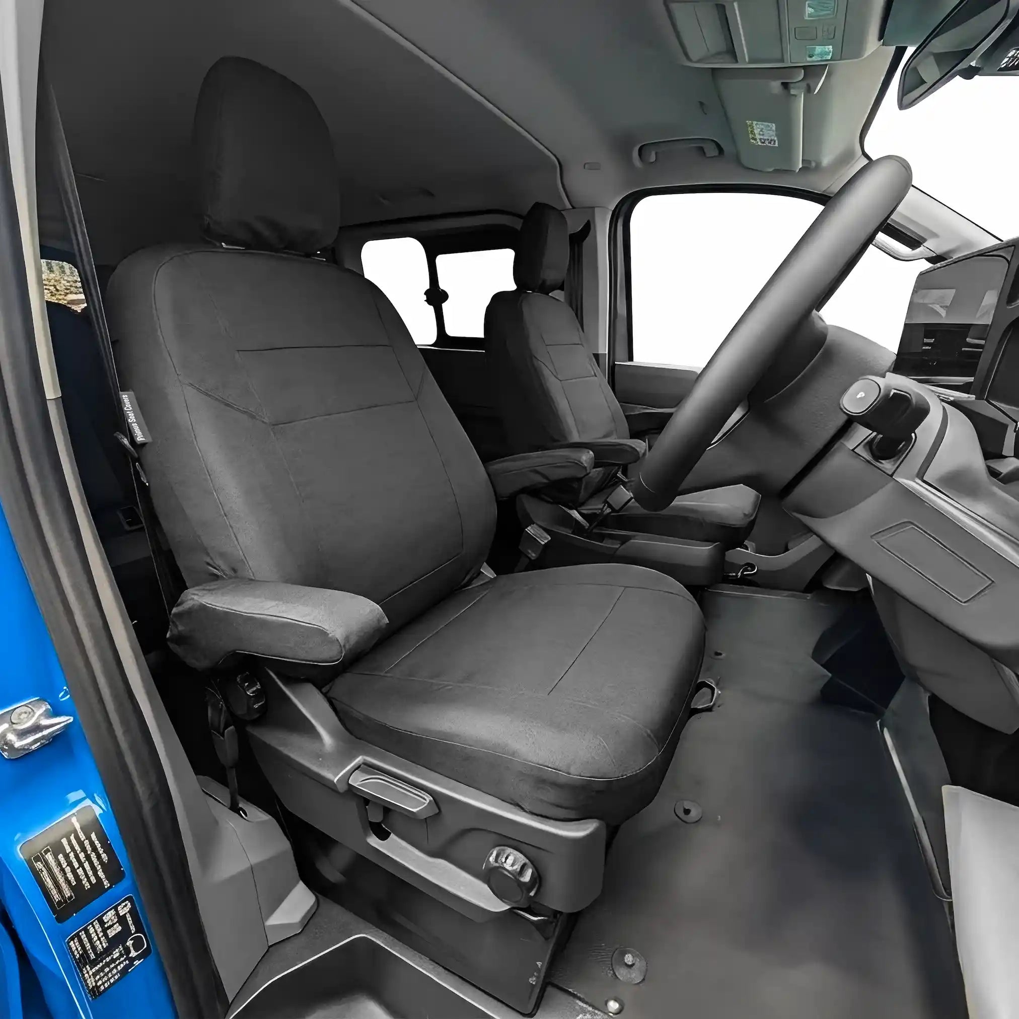 Interior of a Ford Transit Custom with black seat covers fitted.