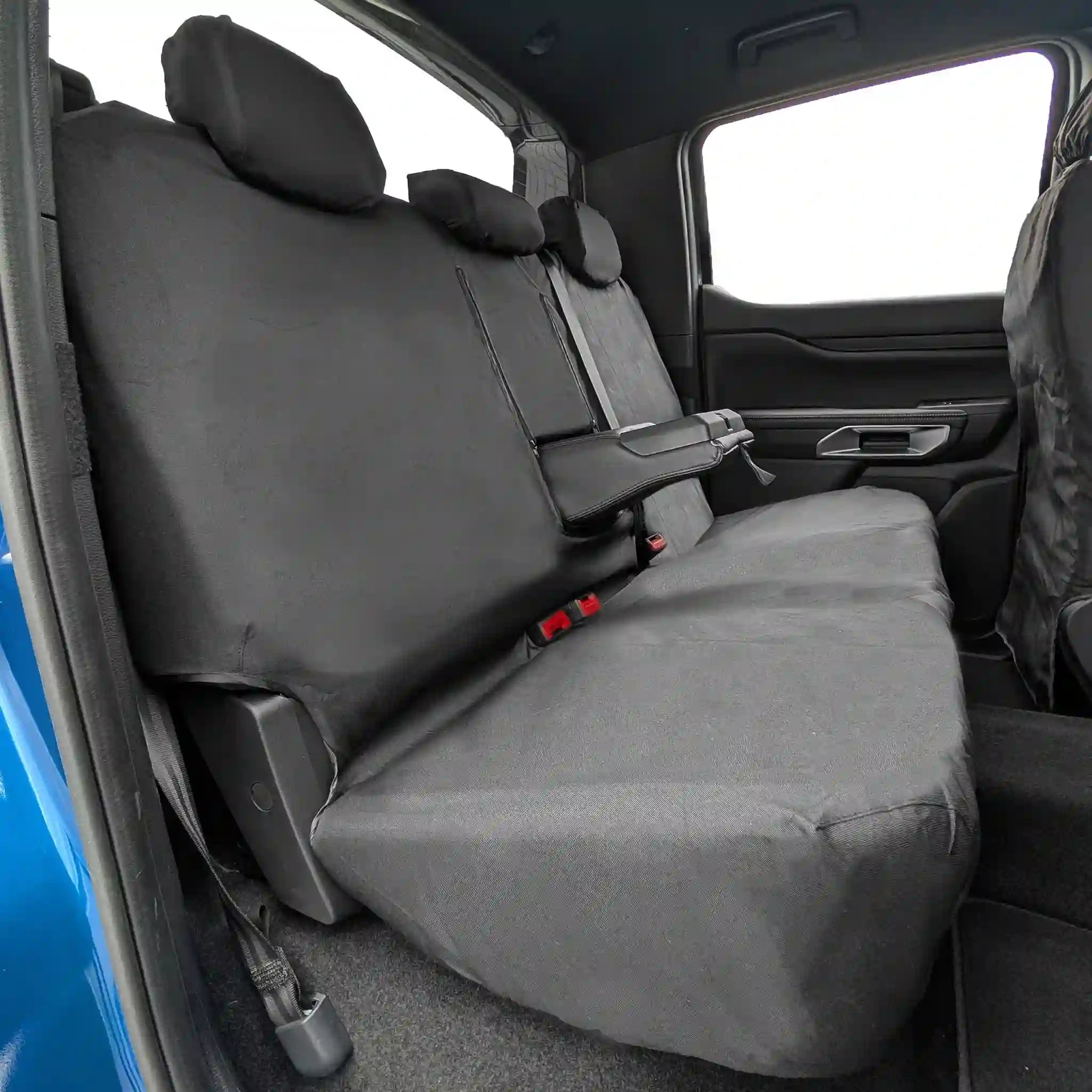Black Ford Ranger waterproof car seat covers on a vehicle's back seat with a blue car exterior visible.