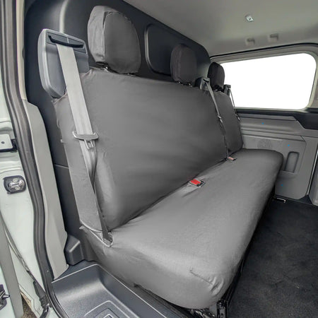 Black Ford Transit Custom rear seat cover on a vehicle's back seat with a visible brand logo