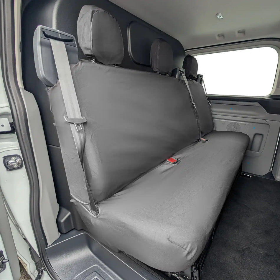 Black Ford Transit Custom rear seat cover on a vehicle's back seat with a visible brand logo