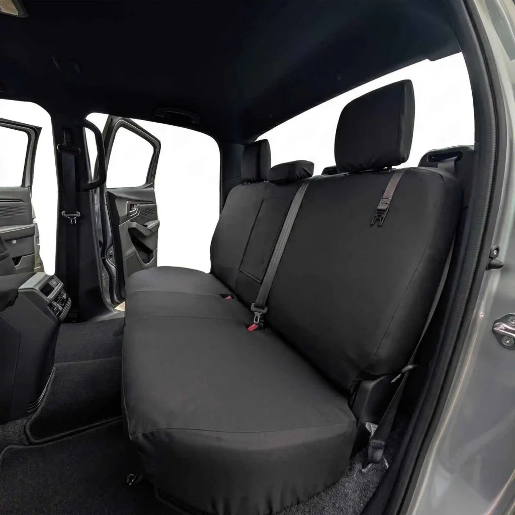 Rear passenger seat cover with headrest and seatbelt access, dark fabric
