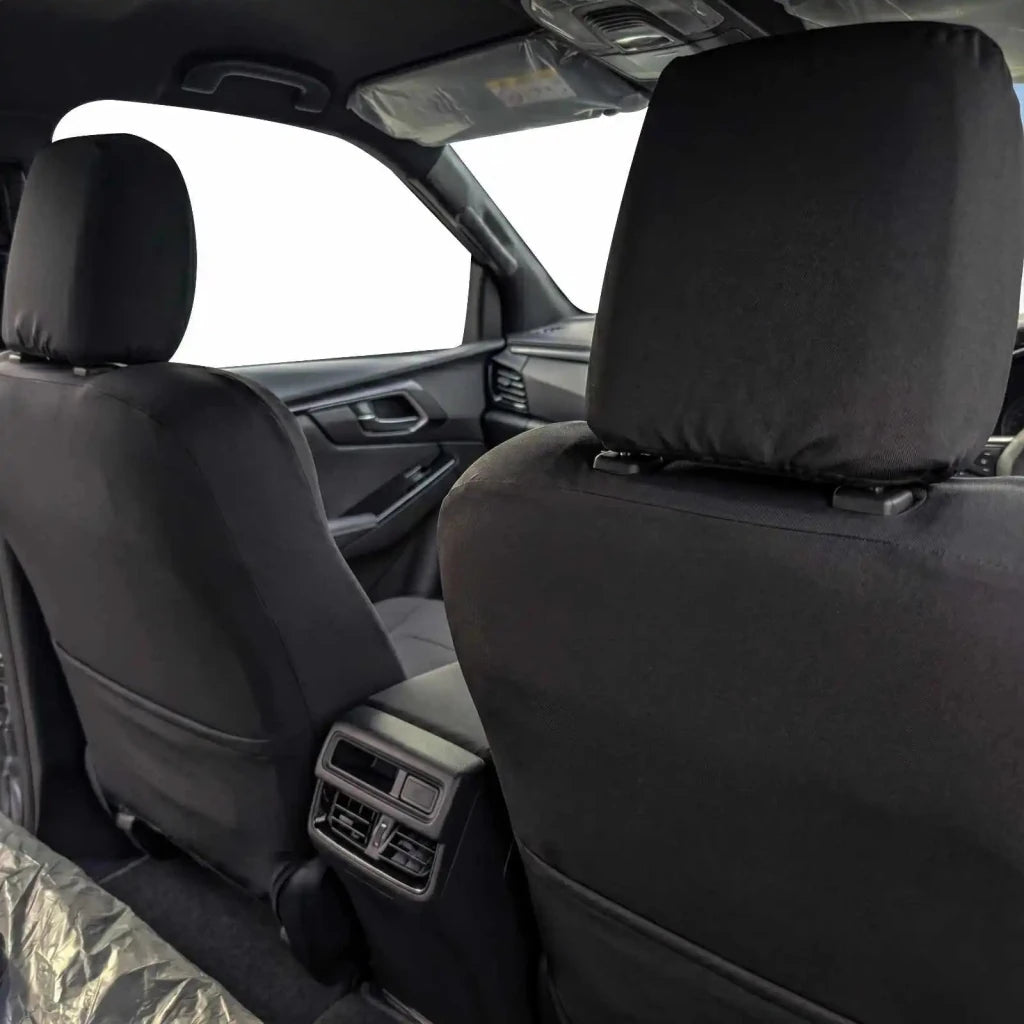 Front seat covers showing headrests and contoured backrests, dark fabric