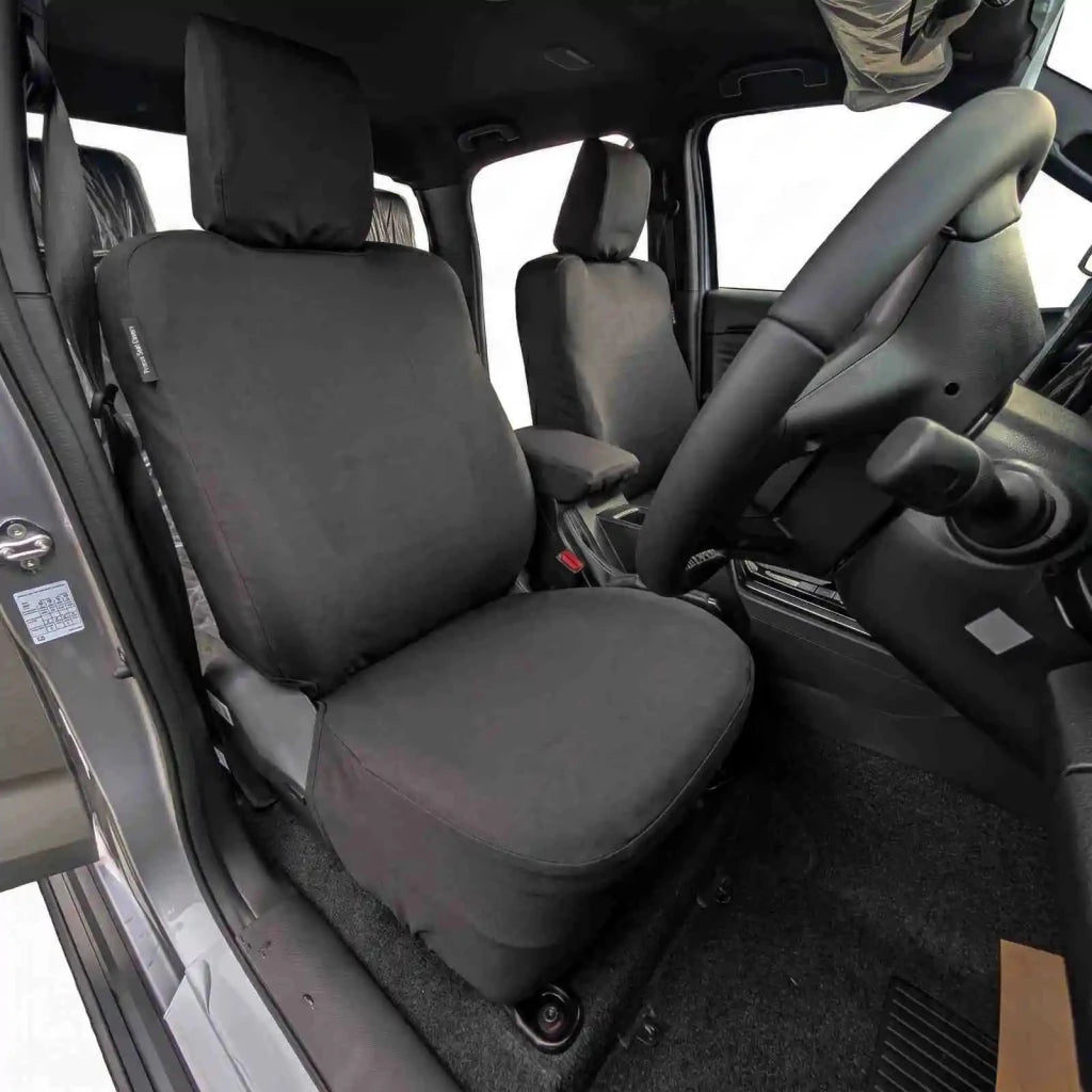 Driver-side seat cover with padded headrest and seat cushion, dark fabric, stitched edges