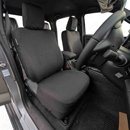 Driver-side seat cover with padded headrest and seat cushion, dark fabric, stitched edges