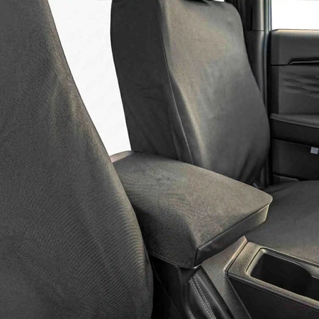 Single seat cover with contoured backrest and armrest cutout, dark fabric, smooth edges