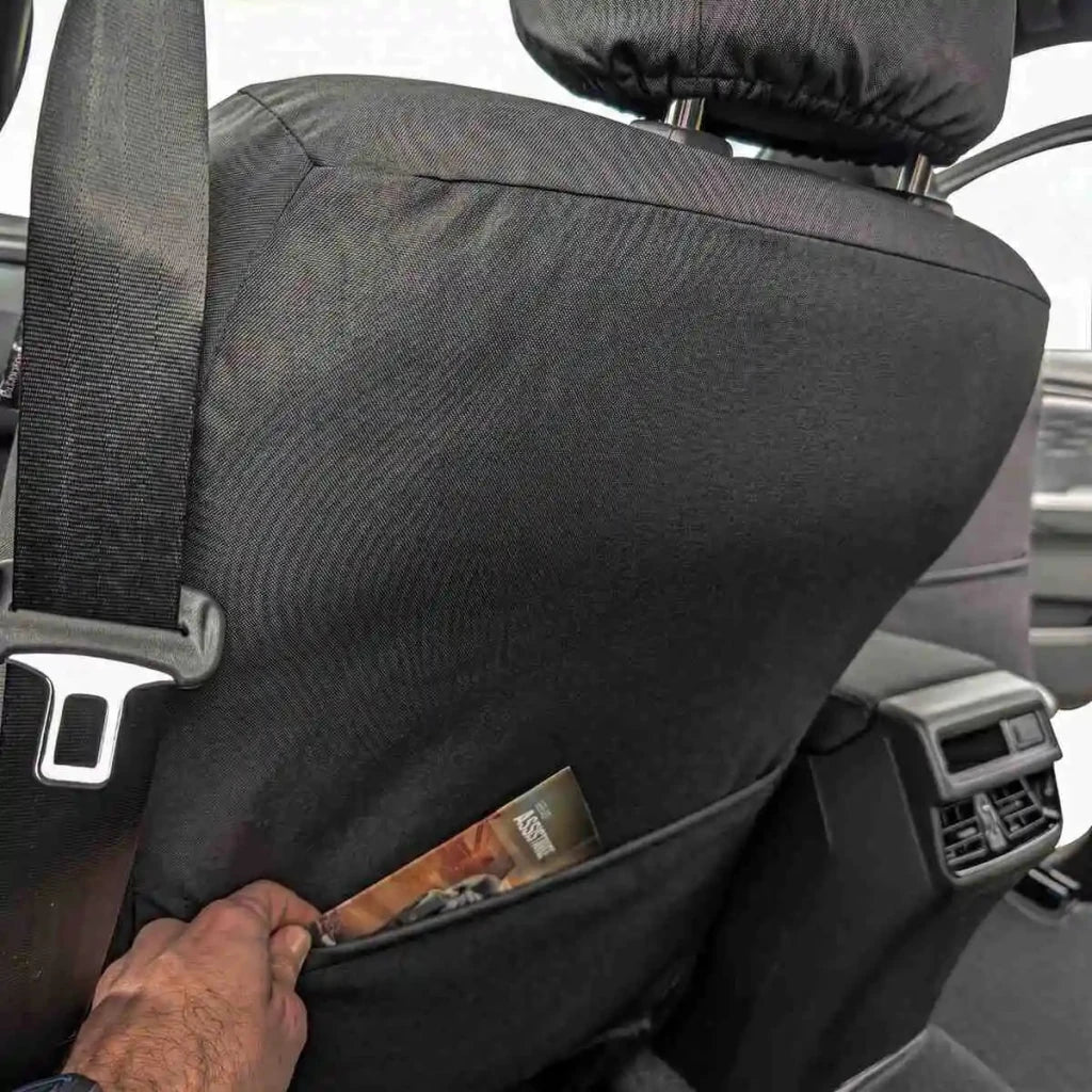 Rear side of seat cover panel with textured fabric and armrest opening, dark