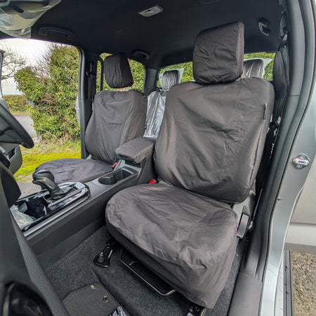 Car interior with gray seat covers on the driver and passenger seats.