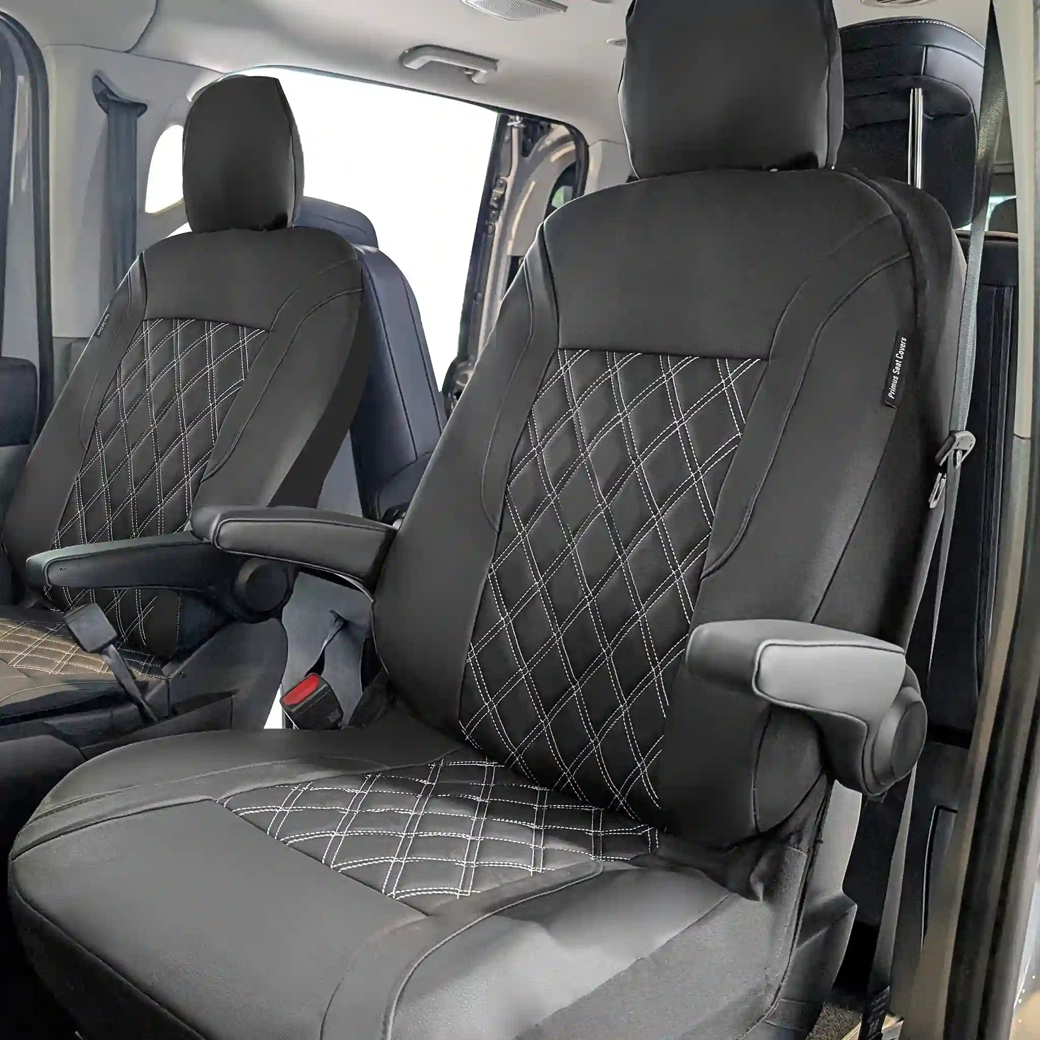 Black car seat covers with diamond pattern in a vehicle interior