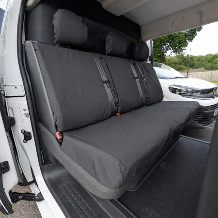 Grey rear bench seat cover with three headrests and center panel straps