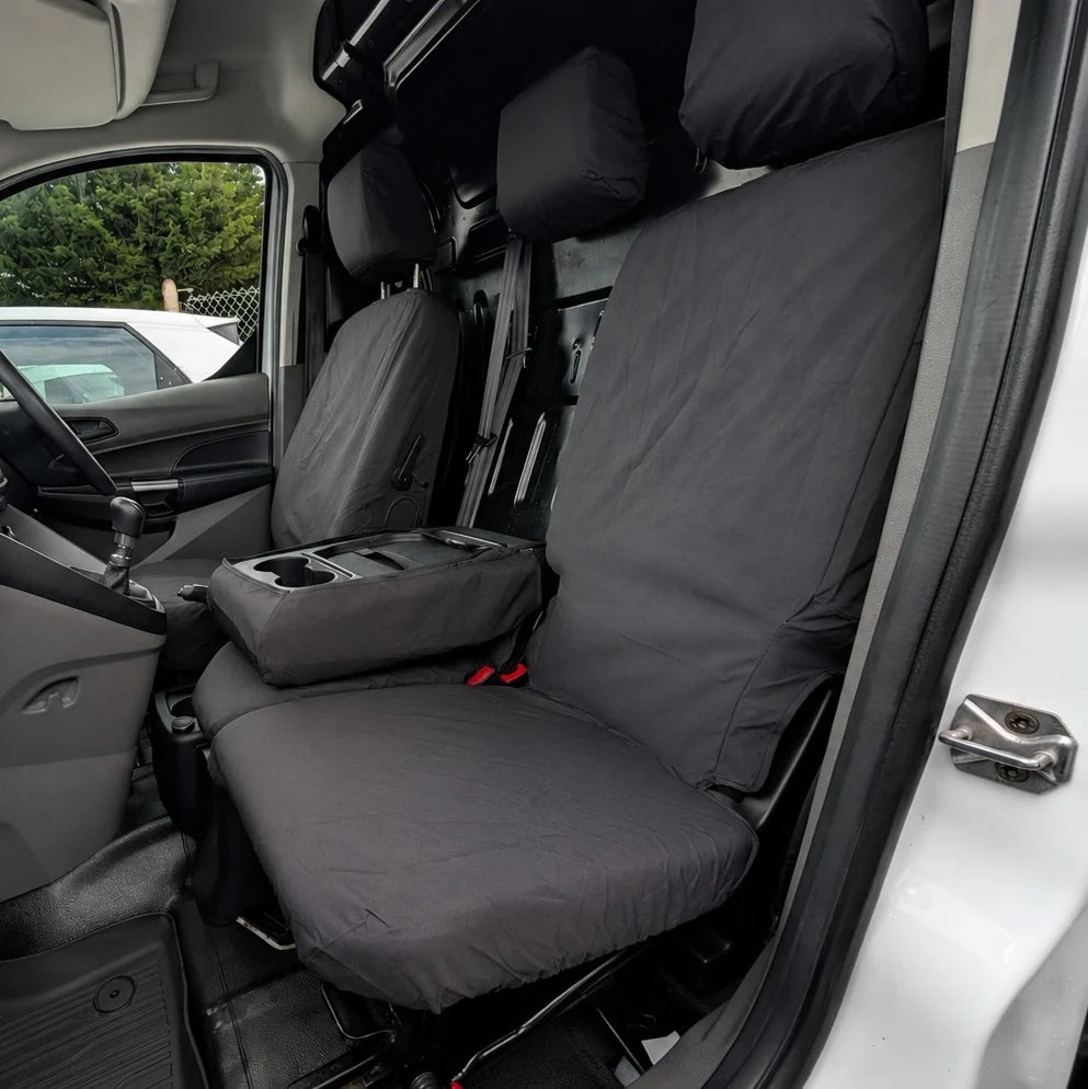 Covered front seats with headrests, dark gray fabric and red attachment points on the cushions