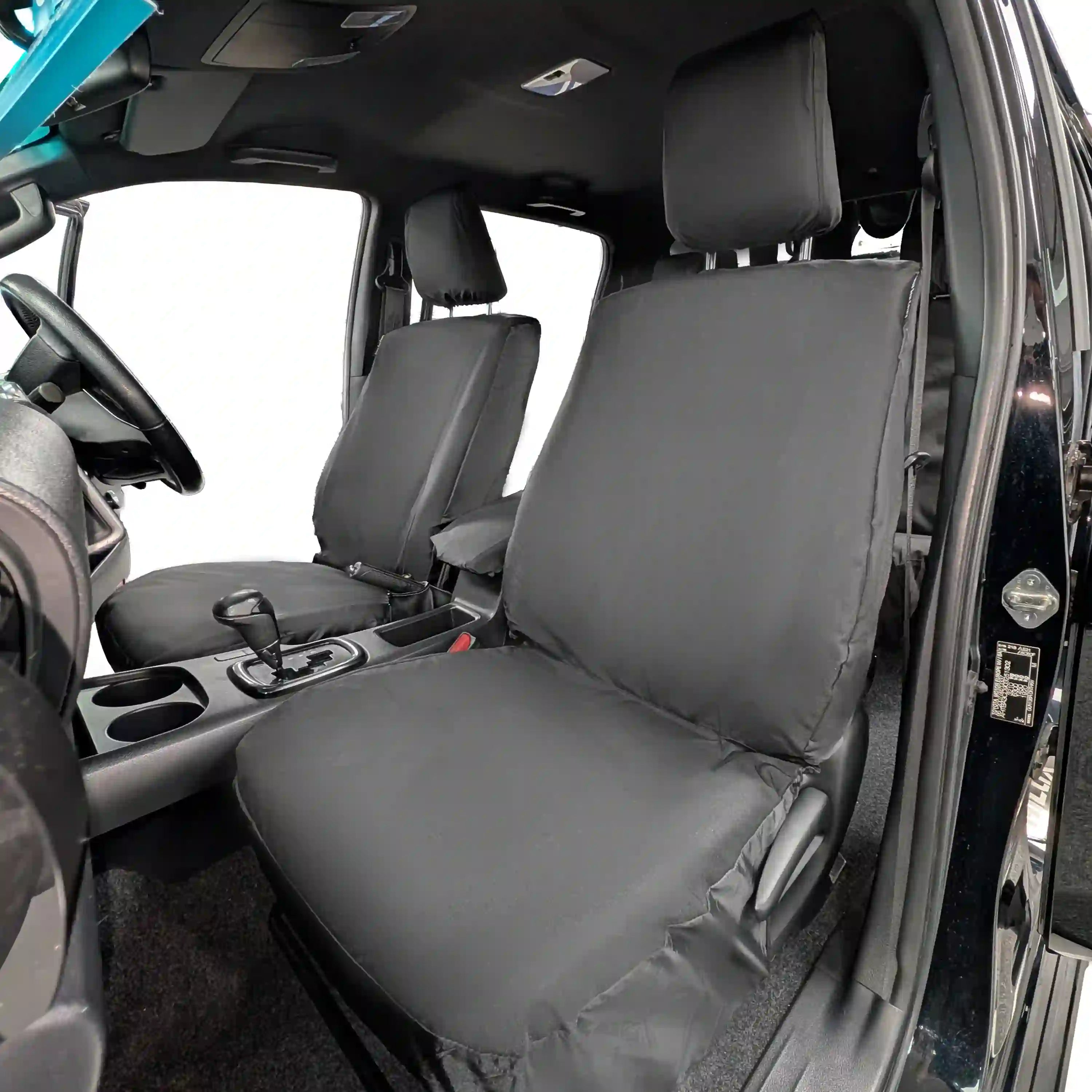 Black Toyota Hilux seat covers installed in a vehicle interior.