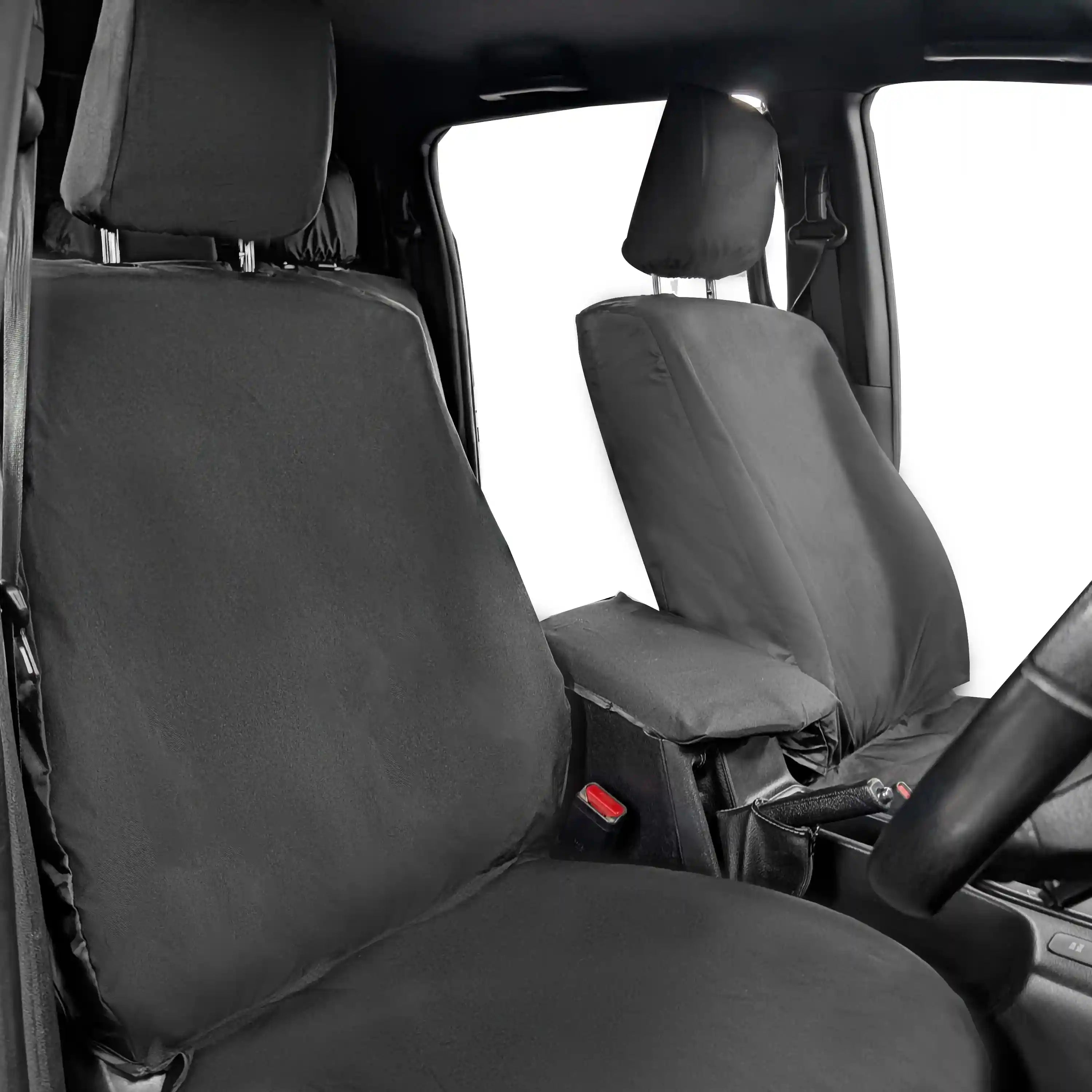 Car interior with black seat covers on the front seats