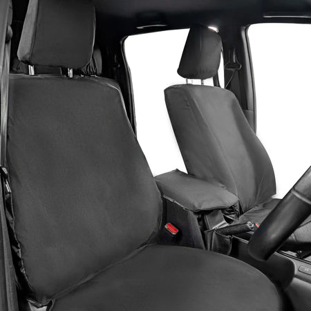 Car interior with black seat covers on the front seats
