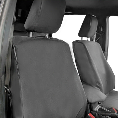 Black car seat covers on a vehicle's front seats with a white background